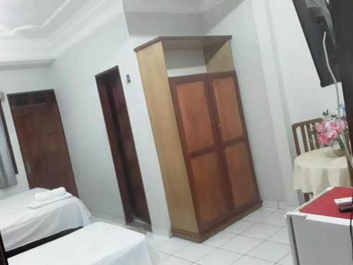 a room with a wooden door and a table at NEW BUSINESS in Macapá