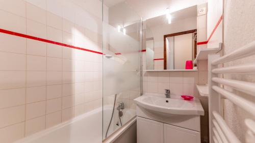 een witte badkamer met een wastafel en een douche bij Grand Morillon 116 - Appt pied des pistes - 5 pers in Morillon
