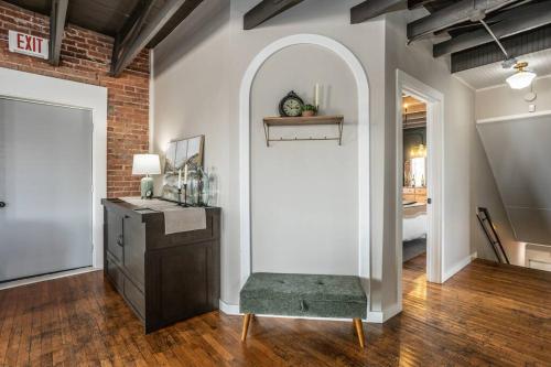 a room with an archway in a brick wall at The Loft at 113 - Gateway to the North Texas Hill Country in Muenster