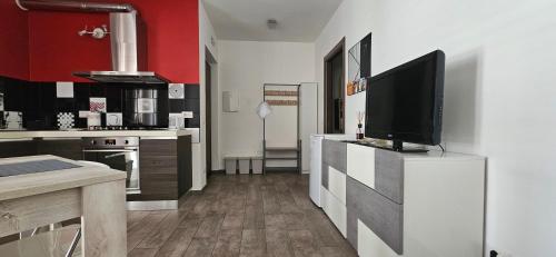 a kitchen with a flat screen tv on a counter at IoEma b&b in Porto SantʼElpidio
