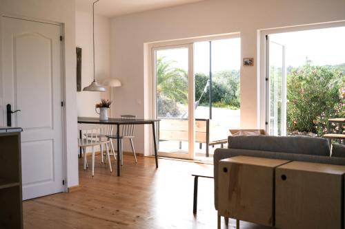 a living room with a couch and a table at Casa Mini & Casa Mia in Aljezur