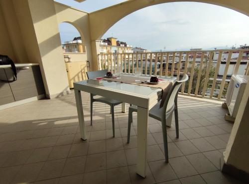 a white table and two chairs on a balcony at Regina Margherita in Rimini