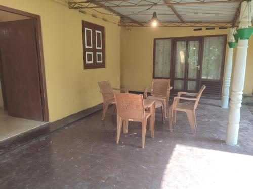 a group of chairs and tables in a room at Cinnamon Villa in Ahungalla