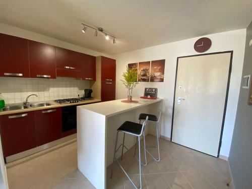 a kitchen with a white counter and a bar with a stool at Leme Bedje - Two bedroom, Pool & Wifi in Santa Maria