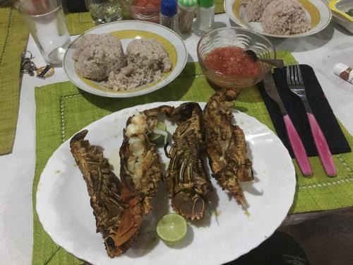 un plato de comida con carne y arroz en una mesa en Le Rocher en Isla Santa María