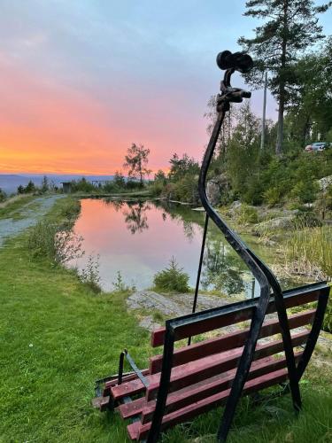 a camera sitting on a bench next to a lake at Kleivstua Hotel near Krokskogen in Sundvollen