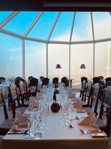 a long table with wine glasses and napkins on it at Kleivstua Hotel near Krokskogen in Sundvollen