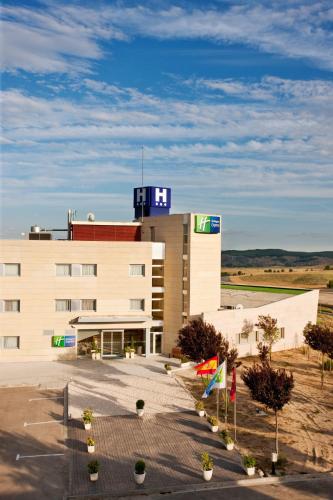 a large building with a sign on top of it at Hotel Holiday Inn Express Madrid-Rivas by IHG in Rivas-Vaciamadrid