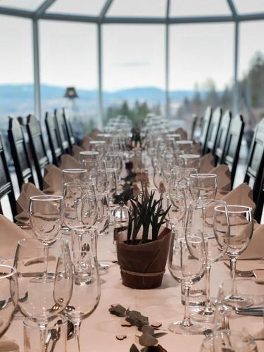 a long table with empty wine glasses on it at Kleivstua Hotel near Krokskogen in Sundvollen