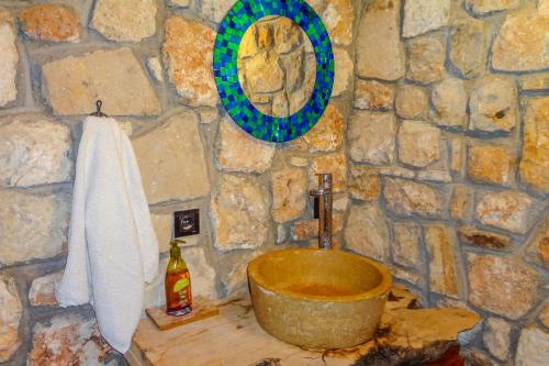 a stone bathroom with a tub and a sink at Naturally Designed Secluded Villa in Kekova in Kaleucagız
