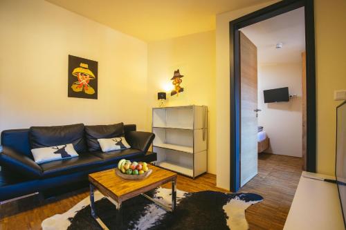 a living room with a couch and a table at Apartmenthotel Oberstdorf in Oberstdorf