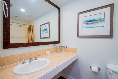 a bathroom with a sink and a mirror at Luau 7012 in Destin