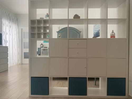 a living room with a large white cabinet at Appartamento "Sabu Home" Napoli Vomero Alto in Naples