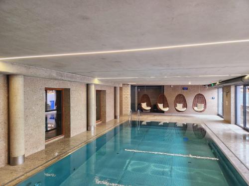a large swimming pool in a building at Apartmenthotel Oberstdorf in Oberstdorf