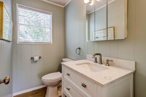 a bathroom with a sink and a toilet and a window at The Happy Place in Edisto Island