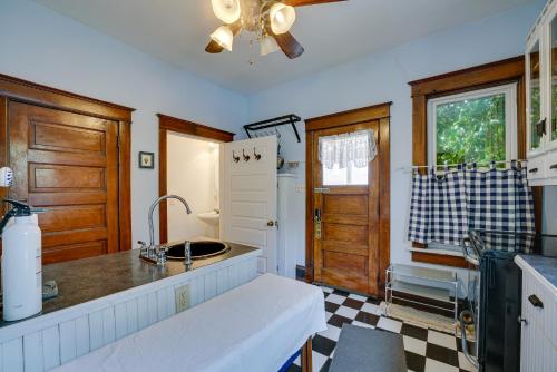 a kitchen with a sink and a counter top at Downtown Victorian Home Near Lake Michigan Beach! in Manistee