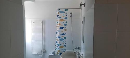 bagno con tenda doccia e lavandino di Ferry House a La Spezia