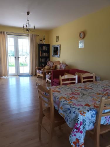 a living room with a table and a couch at Rathgillen Mews in Nobber