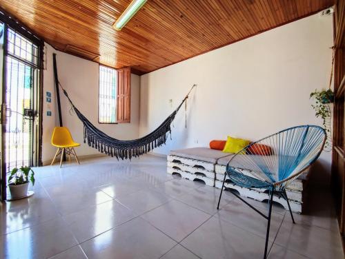 a living room with a couch and a hammock at Bona Vida Hostel in Ríohacha