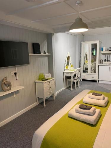 a bedroom with two beds with towels on them at Petherton Cottage Studios in Ringwood