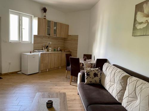 a living room with a couch and a kitchen at Apartment Jovana in Herceg-Novi