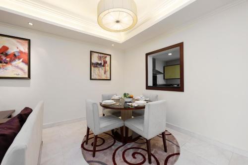 a dining room with a table and chairs at Maison Privee - Charming Apt with Sea View on the Palm Jumeirah in Dubai