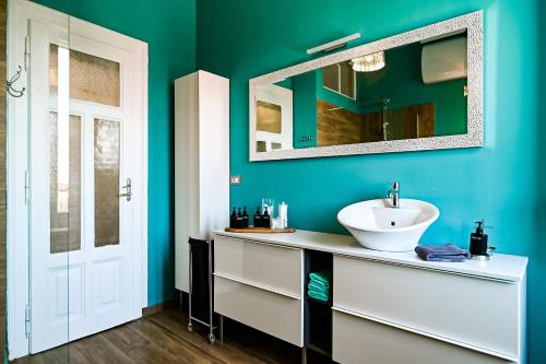 a bathroom with a sink and a mirror at '2R' City Center Holidays and Workstays in Rijeka