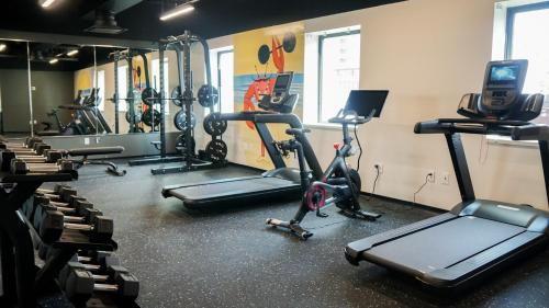 a gym with several treadmills and exercise bikes at The Asbury Hotel in Asbury Park