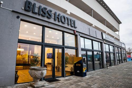 a store front of a building with large windows at Bliss Inn Tunari in Tunari