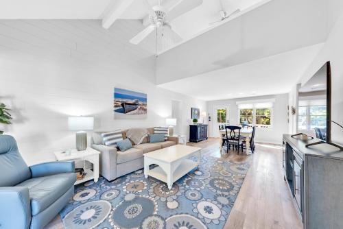 a living room with a couch and a table at 507 Tarpon Pond Cottage in Johns Island