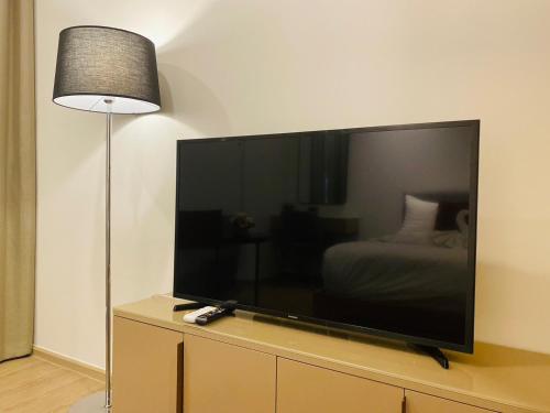 a large flat screen tv sitting on top of a dresser at Edge Central Pattaya Vip Condo in Pattaya Central