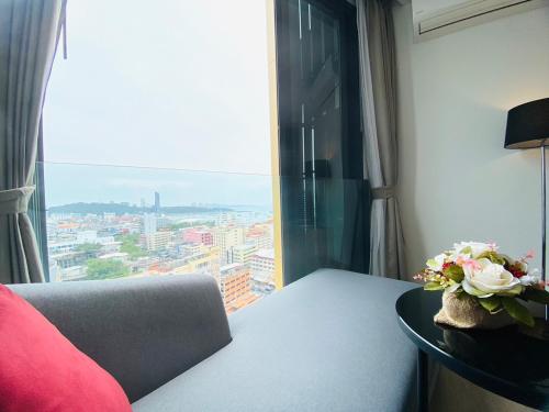 a room with a table with a view of a city at Edge Central Pattaya Vip Condo in Pattaya Central