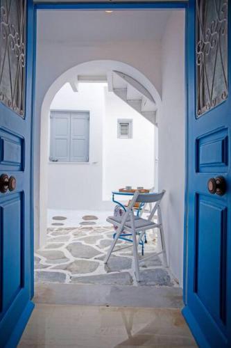 a blue door leading into a room with a table at Nice & Cosy Mykonos studios in Megali Ammos
