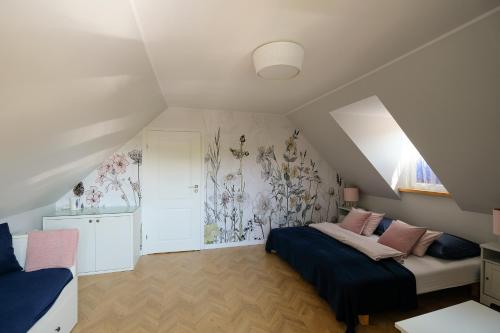 um quarto no sótão com 2 camas e um mural de parede em Pokoje Irys em Kazimierz Dolny