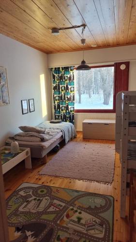 a bedroom with two beds and a large window at Villa Maria in Varkaus