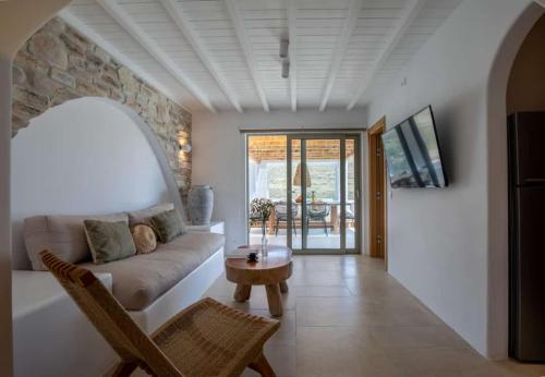 a living room with a couch and a table at Levantes House Mykonos in Ano Mera