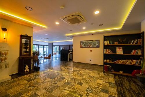 a living room with a book shelf and a hallway at Eleia Hotel İznik in Bursa