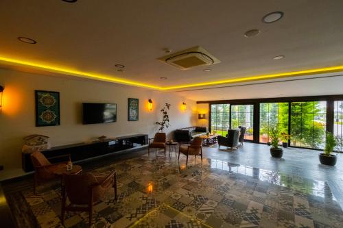 a large living room with a couch and chairs at Eleia Hotel İznik in Bursa