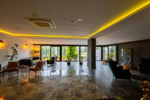 a large lobby with chairs and tables and windows at Eleia Hotel İznik in Bursa