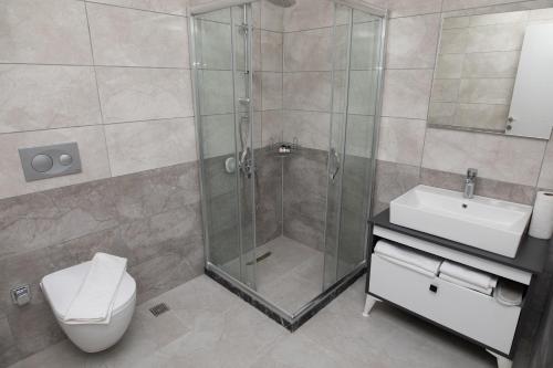a bathroom with a shower and a toilet and a sink at ZOOM HOTEL in Istanbul