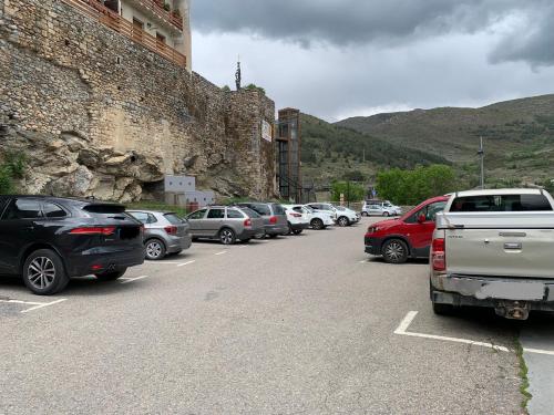 a bunch of cars parked in a parking lot at CAL JAN - La Muralla in Bellver de Cerdanya 