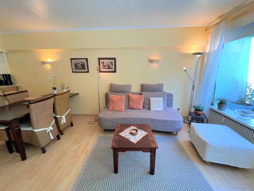 a living room with a couch and a table at Panoramic App C02-1 in Sierksdorf