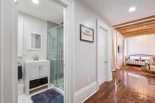 a bathroom with a glass shower and a sink at Carondelet House - 1886 Garden District Manse in New Orleans