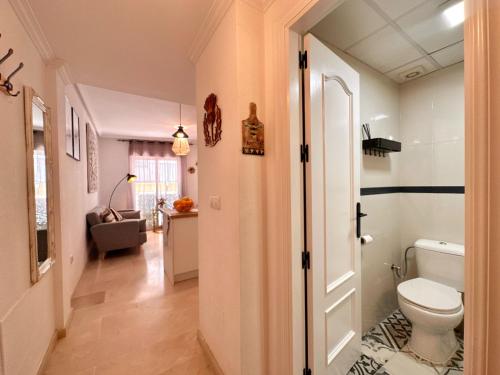 a bathroom with a toilet and a hallway at Casa Playa de Garrucha in Garrucha