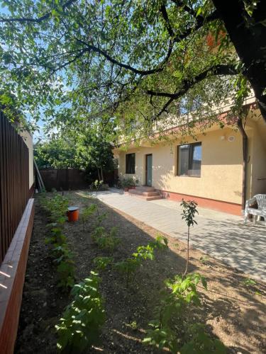 a garden in front of a house at Apusului Residence in Bucharest