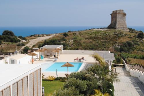 a villa with a swimming pool on a hill at Villa Aries - Rural Chic Experience in Gela
