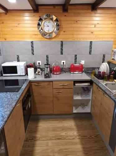 a kitchen with a clock on the wall at Vil'Ariane in Sainte-Marie