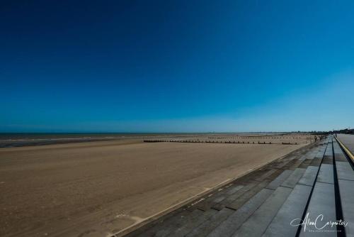 a view of the beach from the pier at Beachside period family home. 5 BR spacious, comfortable. in Dymchurch