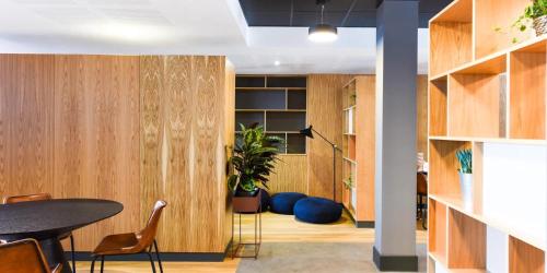 a dining room with wood paneling and a table and chairs at Canvas The Heights in Birmingham in Birmingham