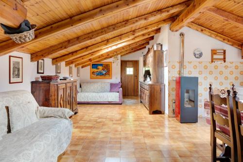a living room with wooden ceilings and a fireplace at Casa Sasia in Casteldelfino